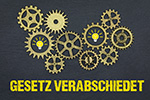 Zahnräder über Schriftzug GESETZ VERABSCHIEDET